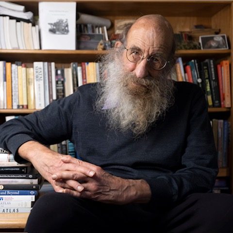 Malcolm with bookcase photo